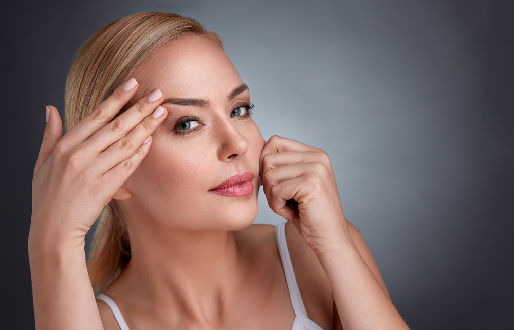 Middle Aged Woman Smoothing Her Skin