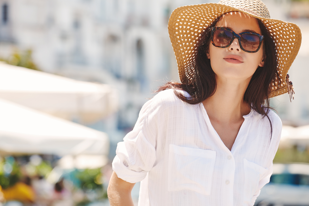 Young Woman Wearing Hat and Sunglasses