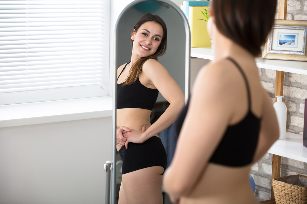 woman looking at silhouette in mirror